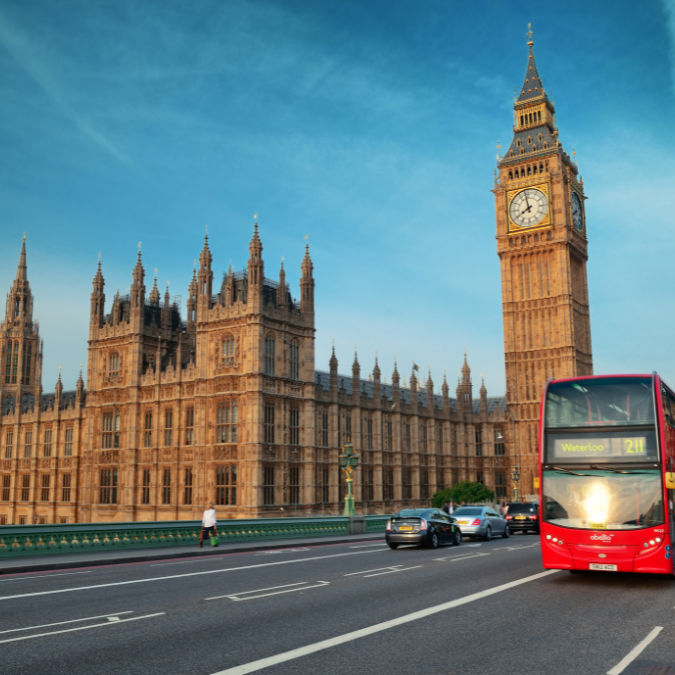 side face of a black man smiling in a light blue background